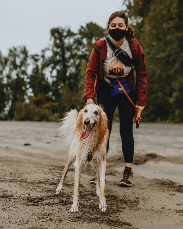 A photo of me and my dog Argus on a river beach after a hike.